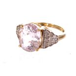 An 18ct gold pink topaz and diamond ring, the large pink topaz set in claw mount, flanked by small