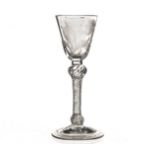 An 18th century wine glass, with funnel bowl engraved with floral spray and insect decoration, on