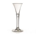 An 18th century wine glass, with drawn trumpet bowl on a tear drop stem, on a folded foot 17cm H