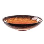 A large Monart Ware glass bowl, the wide and shallow form with short foot with black rim leading