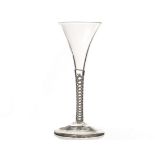 An 18th century wine glass, with drawn bowl and double cotton twist stem, on a plain foot 16cm H