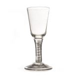 An 18th century wine glass, with tall pail shaped bowl on a multi cotton twist, on a plain foot 16cm