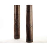 A pair of Chinese bamboo stick stands, the long cylinders with lead weighted bases having carved