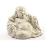 A Chinese blanc de chine porcelain figure of Buddha, the white glazed seated figure holding rosary