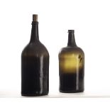 An 18th century mouth blown bottle of shouldered cylindrical form with drawn neck deep brown