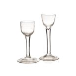 A mid-18th century wine glass, the rounded funnel bowl above a plain stem and fold-over foot, plus a