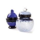 Two Monart glass jars and covers, one mottled cobalt blue and purple, the domed cover matching