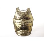 A Russian brass breast plate, with embossed double headed eagle and other designs