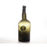 An early 19th century green sealed wine bottle of shouldered cylindrical form, with kick-up base and