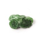 A small Chinese jadeite pendant, the green hardstone carved with flowers and other motifs, drill