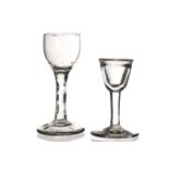 A late 18th century cordial glass, with facetted stem, together with a smaller example with a