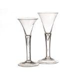 Two 18th century wine glasses of drawn trumpet form with tear drop captive bubble stems, 17.5cm (