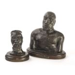 Two vintage African spelter figures of Zulu warriors, the larger with chest and head on a plinth