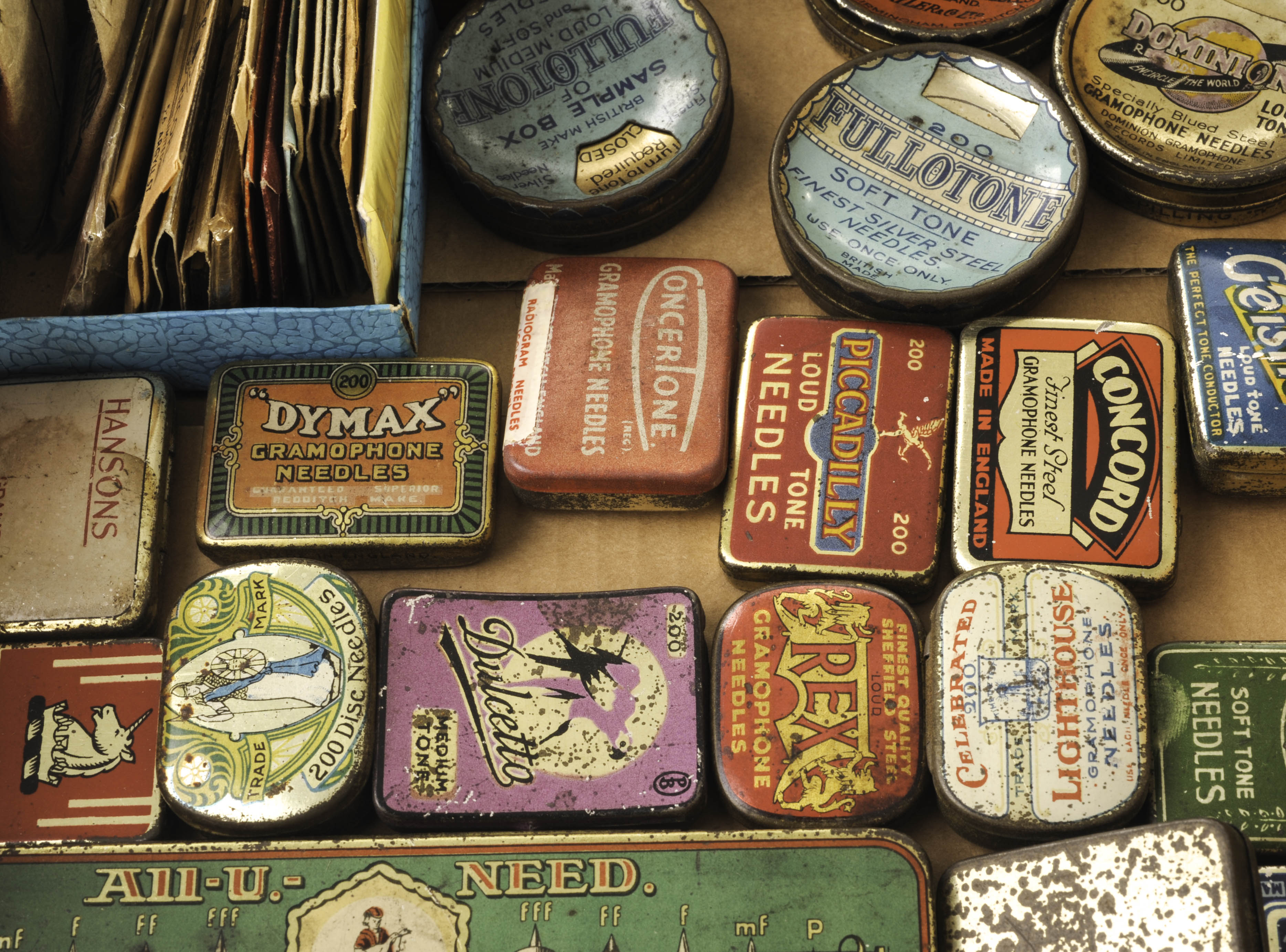 Needle tins: an All-U-Need five-compartment tin; six circular tins; fourteen others; a wood box; and