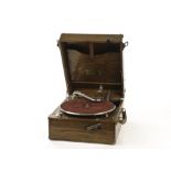 Portable gramophone: a Uni­tone portable gramophone in oak case with folding front winder (lacking