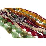 A selection of various costume necklaces, to include an amber bead necklace, an ivory dish necklace,