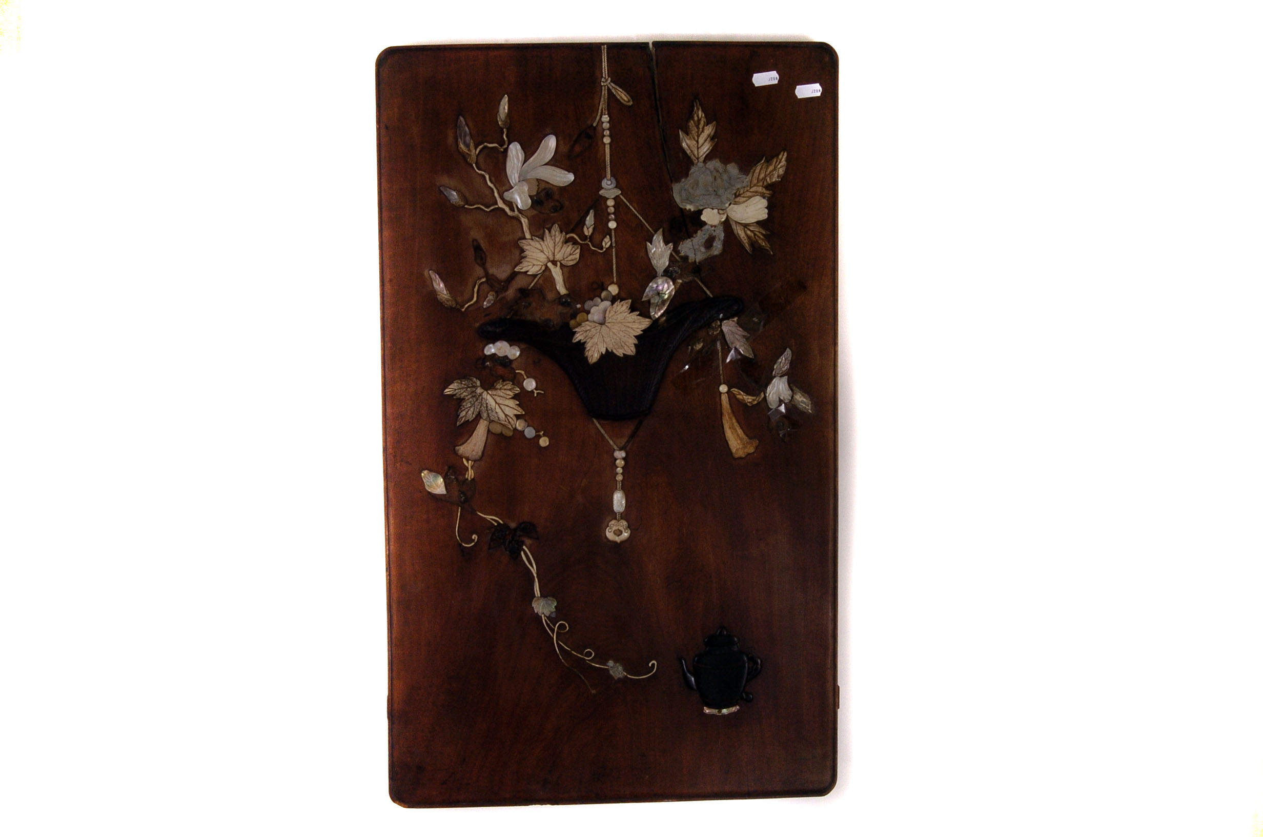 A decorative panel of floral design, with added mother of pearl, bone/ivory and ebonised wood relief