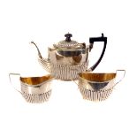 A matched silver three piece bachelors tea set, comprising a Victorian teapot marked Chester 1898,