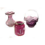 A Mary Gregory cranberry glass jar and cover, together a smaller beaker example, plus two pieces