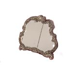 A silver framed Rococo mirror, having a decorative swag design frame, with bevelled glass, AF