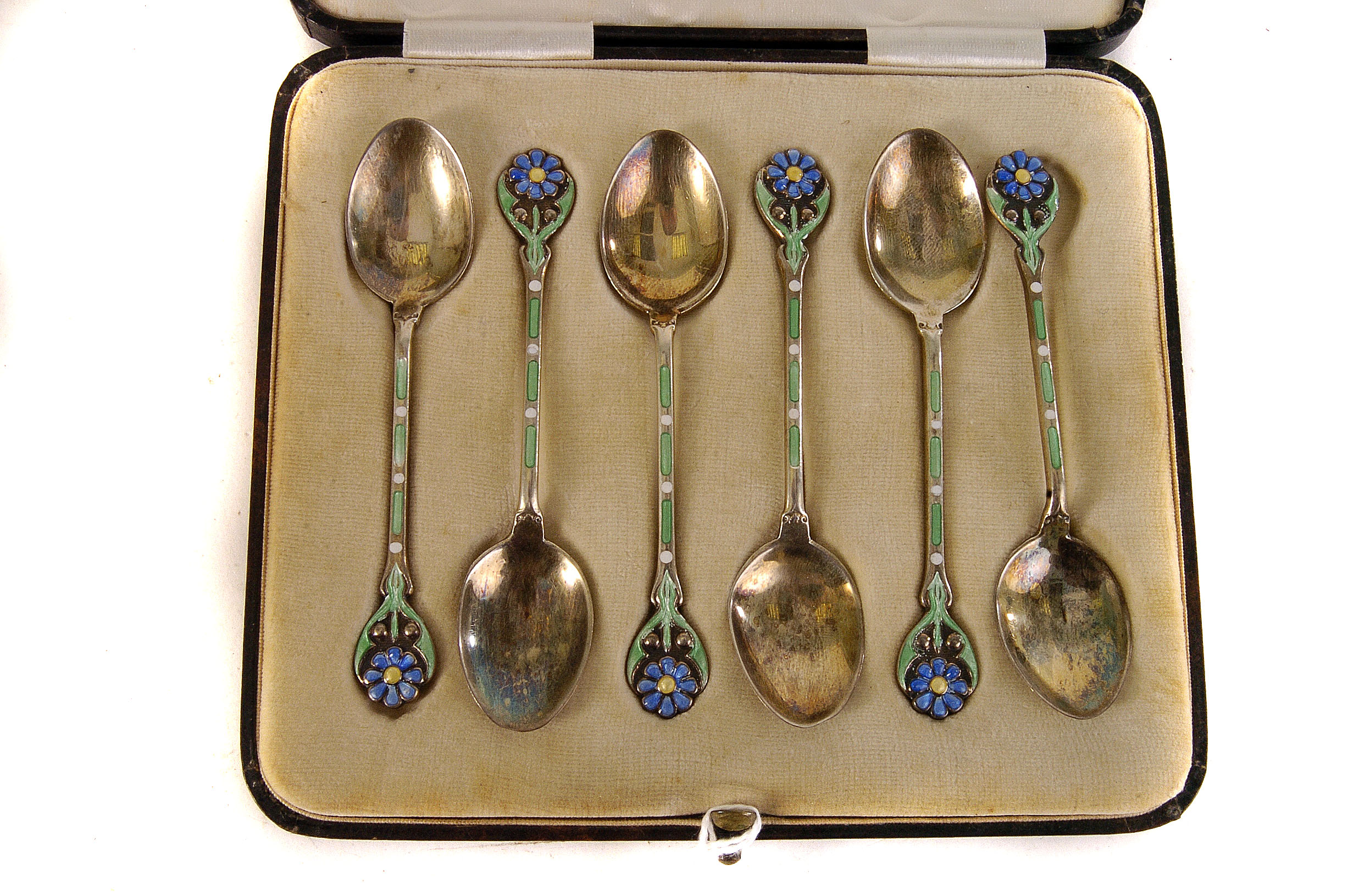 A cased set of six George V silver and enamel tea spoons, marked Birmingham 1937 by T&S, with