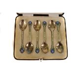 A cased set of six George V silver and enamel tea spoons, marked Birmingham 1937 by T&S, with