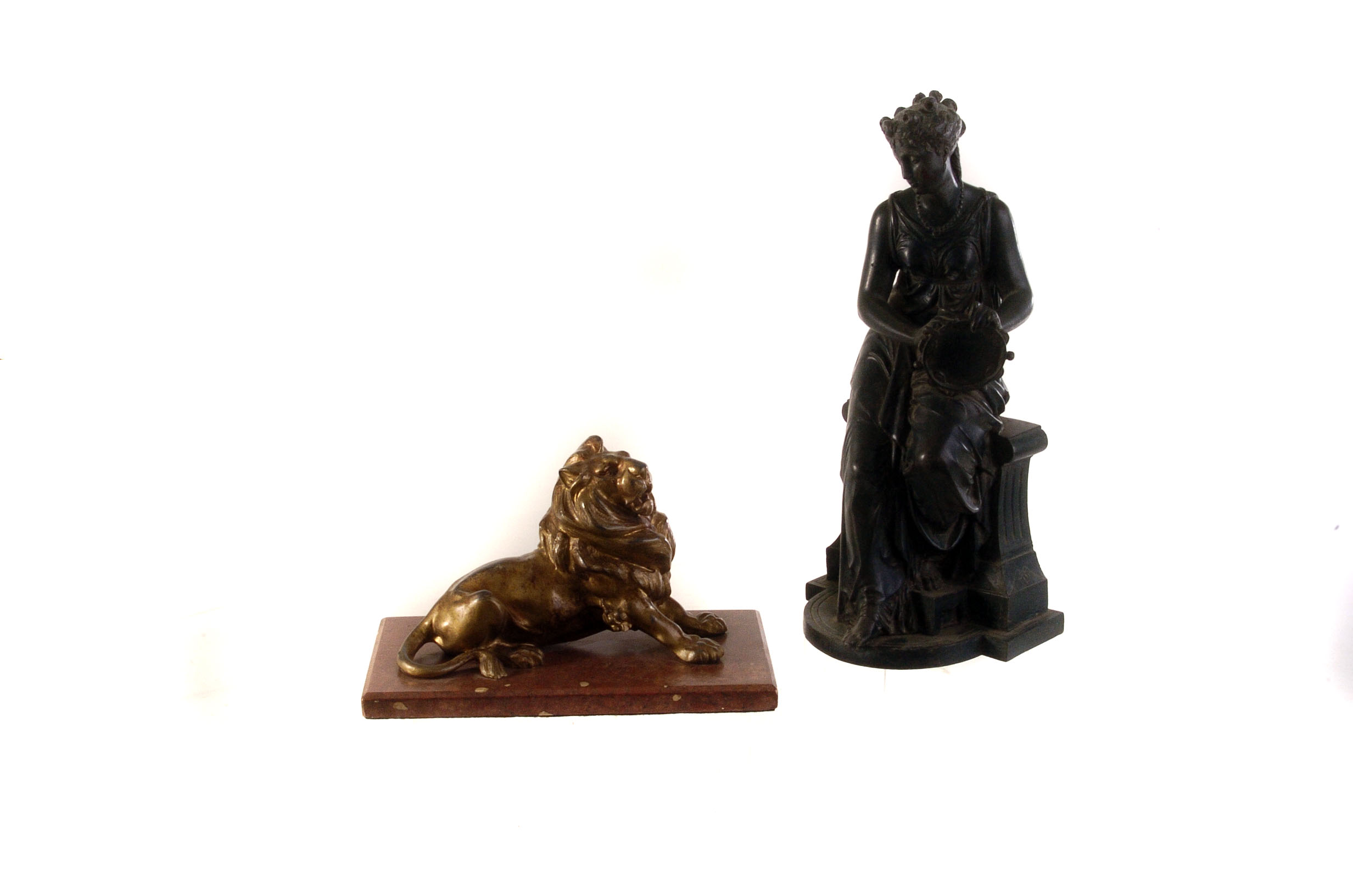 A spelter figure of a young woman playing a tambourine, marked Couret to bottom, together with a