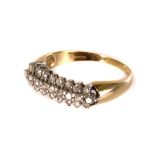 An 18ct gold and diamond cluster style ring, the tablet made up of three rows of small brilliant