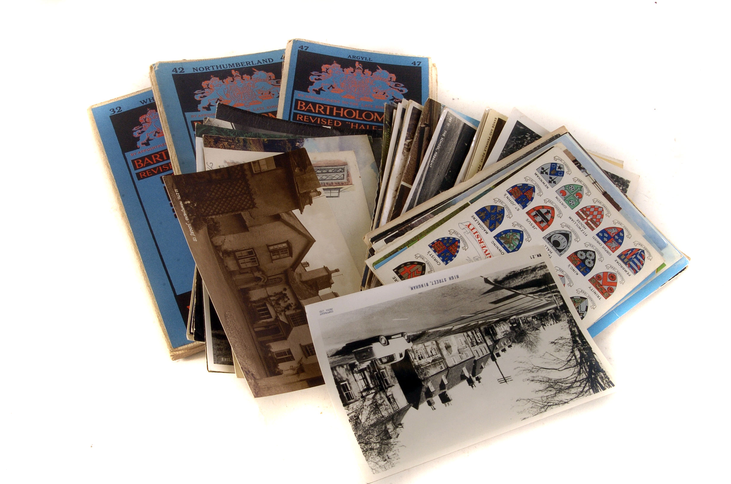 An assortment of postcards, various locations and ages, together with various road maps of various