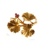 An 18ct gold vine leaf spray brooch, hallmarked Birmingham, having plain tendril design, one set