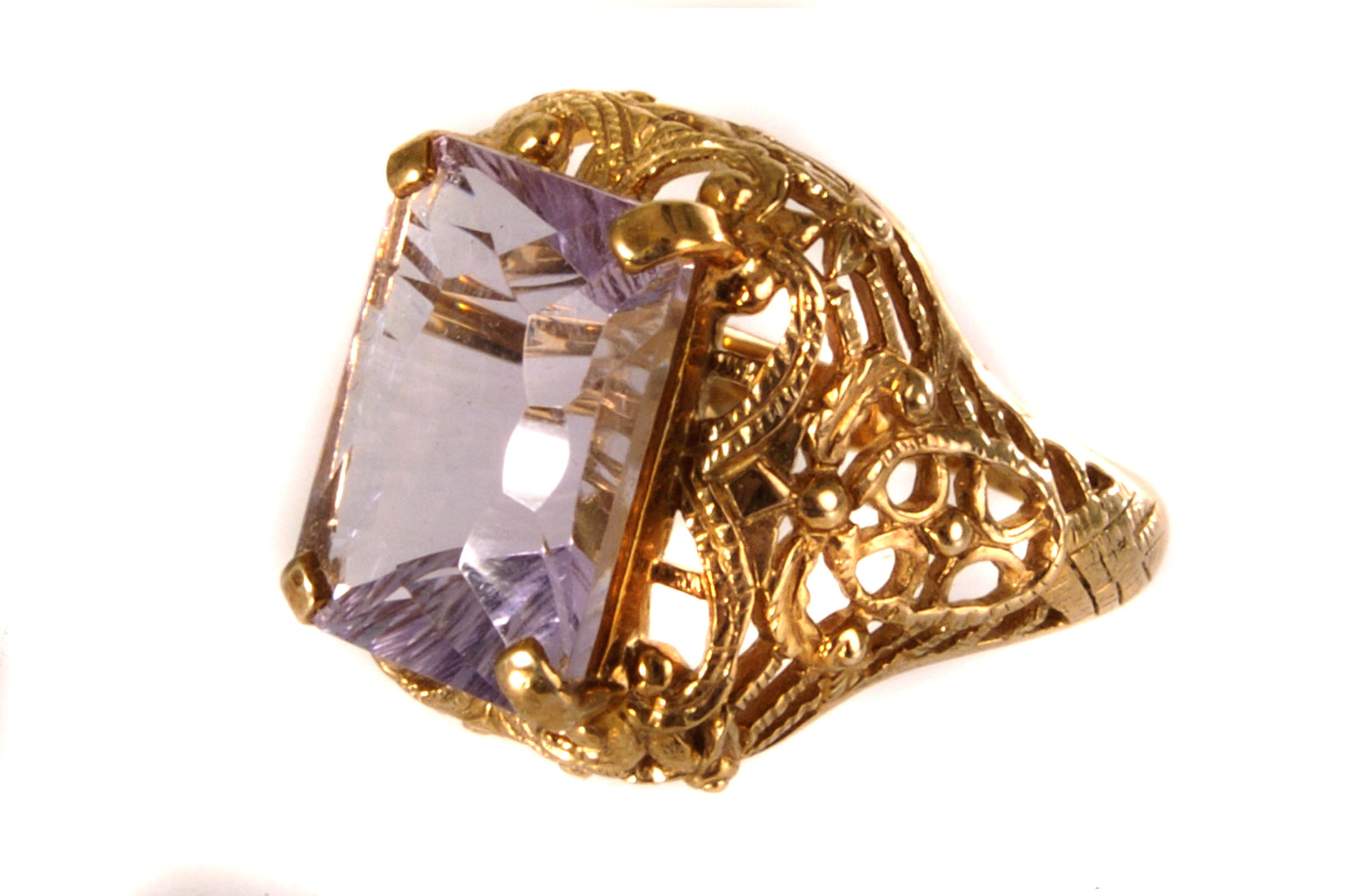 A 9ct gold and amethyst dress ring, the large mixed step cut stone in four claw mount, with