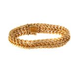 A 18K marked gold double row curb bracelet, having snake skin pattern to each link with single row