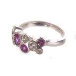 A pretty platinum diamond and pink sapphire dress ring, the abstract tablet set with randomly rubbed