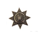 A Victorian silver military chest badge, in the form of a star, with central fusiliers horn and