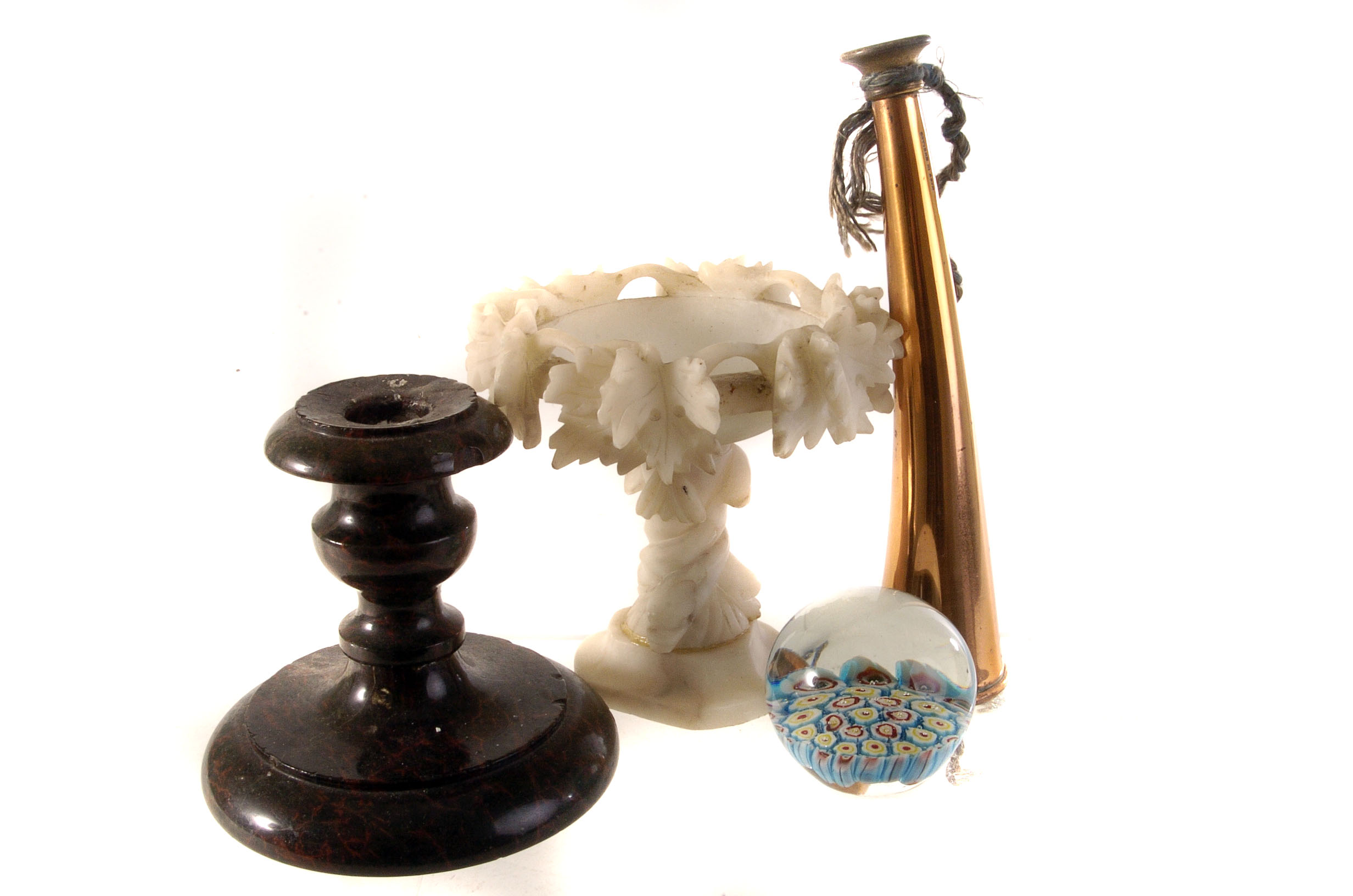 A small collection of works of art, including a glass paperweight, hardstone urn and candle stick, a