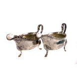 A pair of silver sauce boats, marked London 1900, with crest marked to the side 'His Victmus Armis',