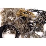 An assortment of paste set costume jewellery, including a fringe necklace, a bow brooch, a heart