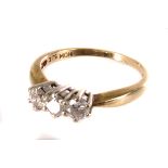 A vintage three stone diamond engagement ring, the three brilliant cuts in white metal claws on a