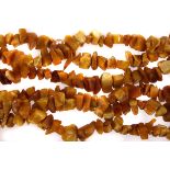 A rough amber bead necklace, the long string of toffee and yellow coloured amber pieces strung on