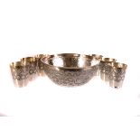 A Middle Eastern silver bowl, with pressed floral and swag design, together with a set of six Middle