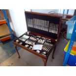 A large canteen of silver plated cutlery on stand, comprising knives, forks, carving set, serving