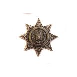 A Victorian silver military chest badge, in the form of a star, with central fusiliers horn and stag