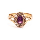 An antique gold and gem set ring, having a cut pink stone surrounded by seed pearls on 9ct gold band