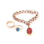 A curb link bracelet with carved carnelian charm, the 9ct gold bracelet supporting an oval carnelian