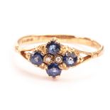 An antique style 9ct gold and gem set ring, the diamond shaped tablet with four blue cut stones