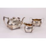 A George III silver three piece tea set possibly by John Wren, having flared gadrooned rims and part