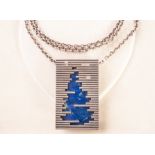 A Danish silver and lapis lazuli pendant by designer Jan Lohmann c.1970, as an abstract rendition of