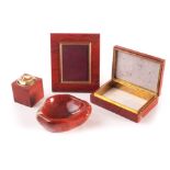 An Asprey of London red jasper companion set, comprising a cigarette box, table lighter, ashtray,