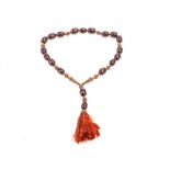 A vintage Ethiopian cherry amber necklace, the large ovoid beads strung with filigree white metal