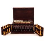 An Edwardian games compedium box, having fret handles, the swing doors containing boxwood and